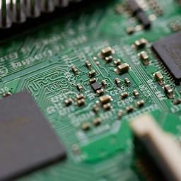 a close up of a green motherboard with a lot of electronics on it .
