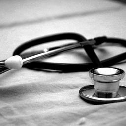 a black and white photo of a stethoscope on a table .
