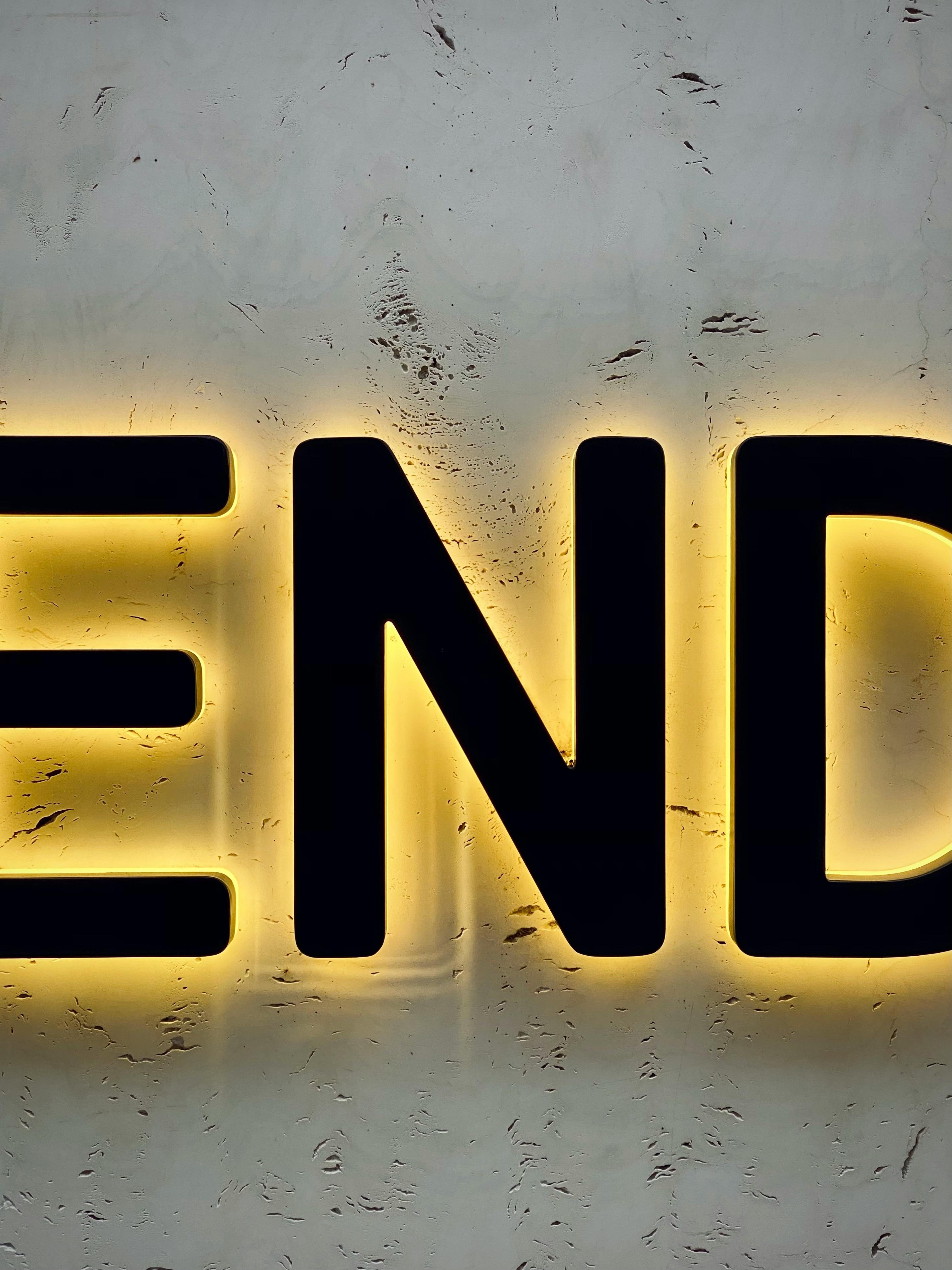 the word end is lit up on a wall