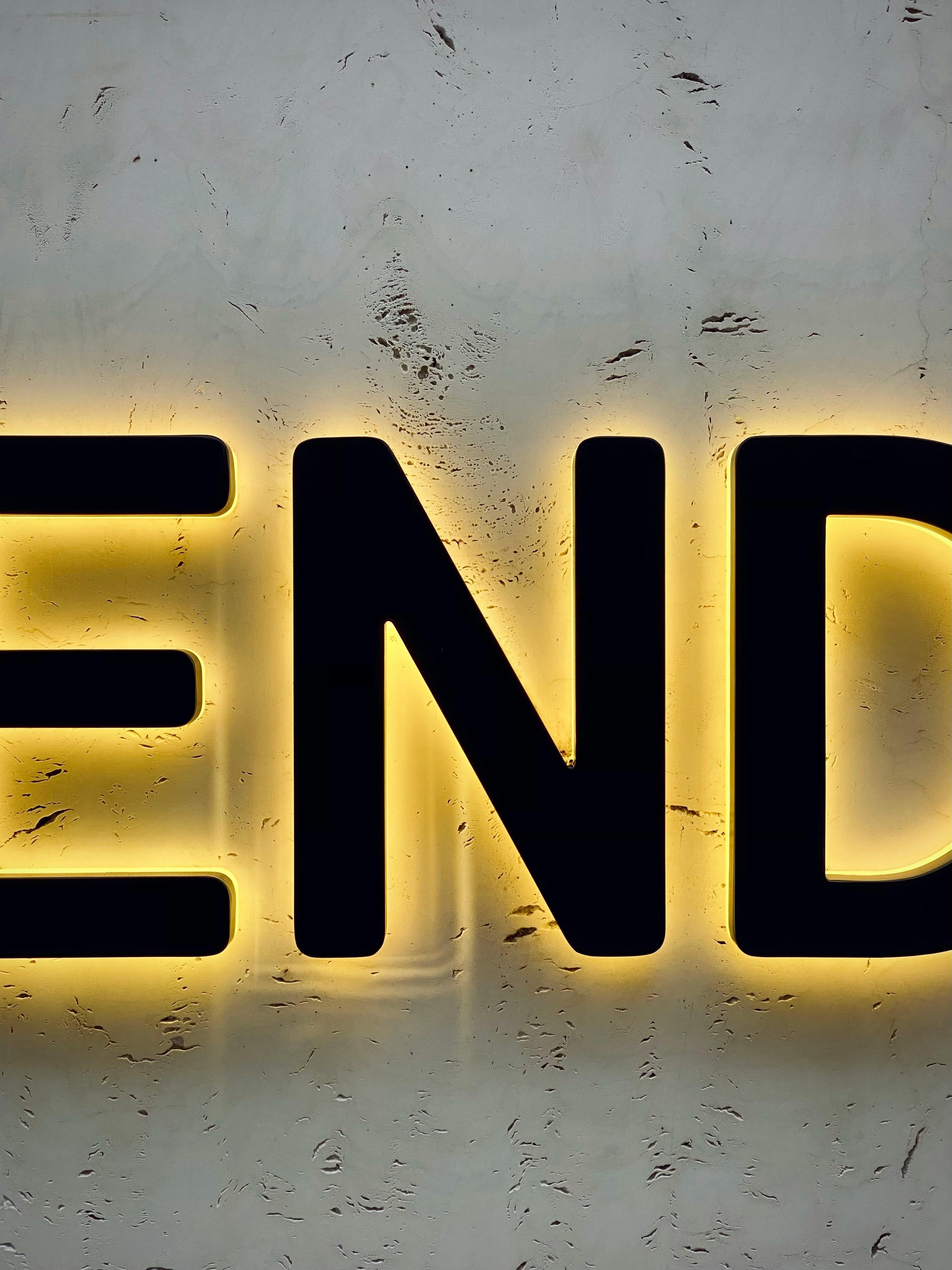 the word end is lit up on a wall