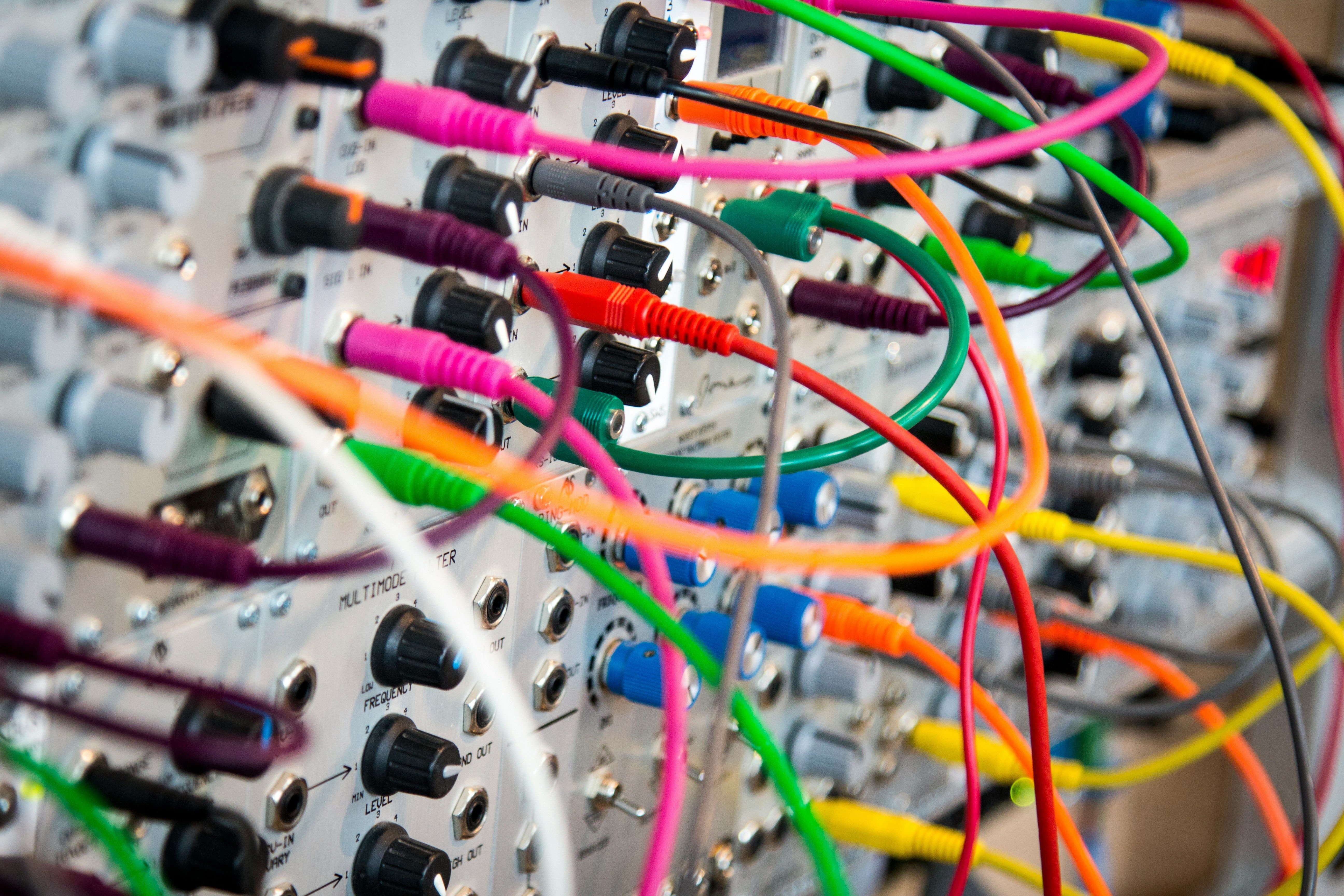a bunch of colorful wires are connected to a computer .