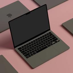 a group of laptops are sitting on top of each other on a pink surface .