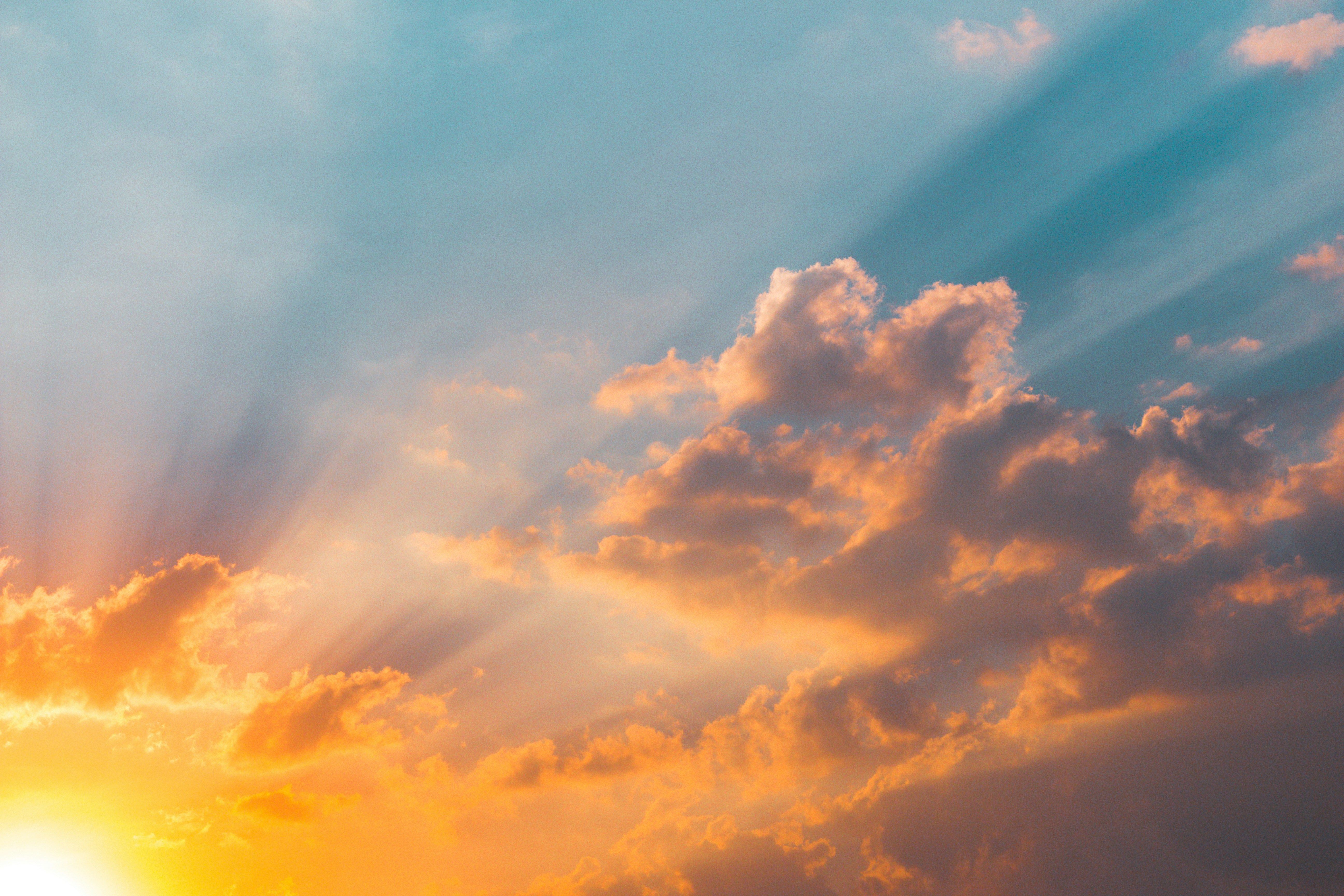 the sun is shining through the clouds at sunset .