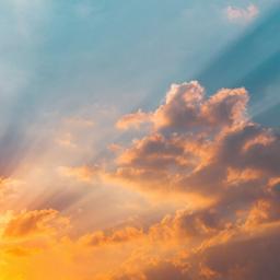 the sun is shining through the clouds at sunset .