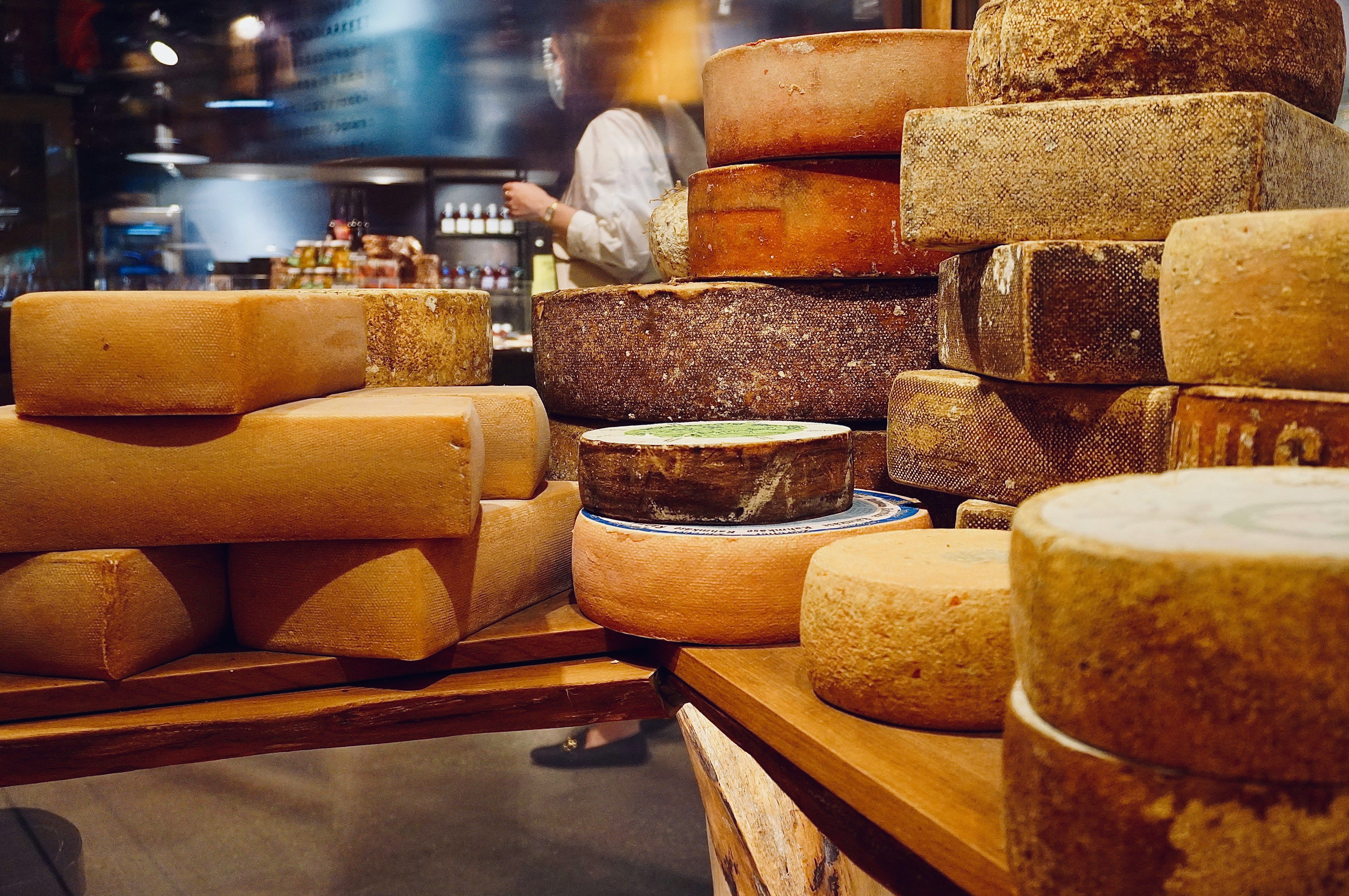 there are many different types of cheese stacked on top of each other .