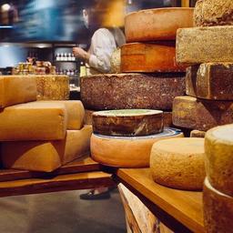 there are many different types of cheese stacked on top of each other .