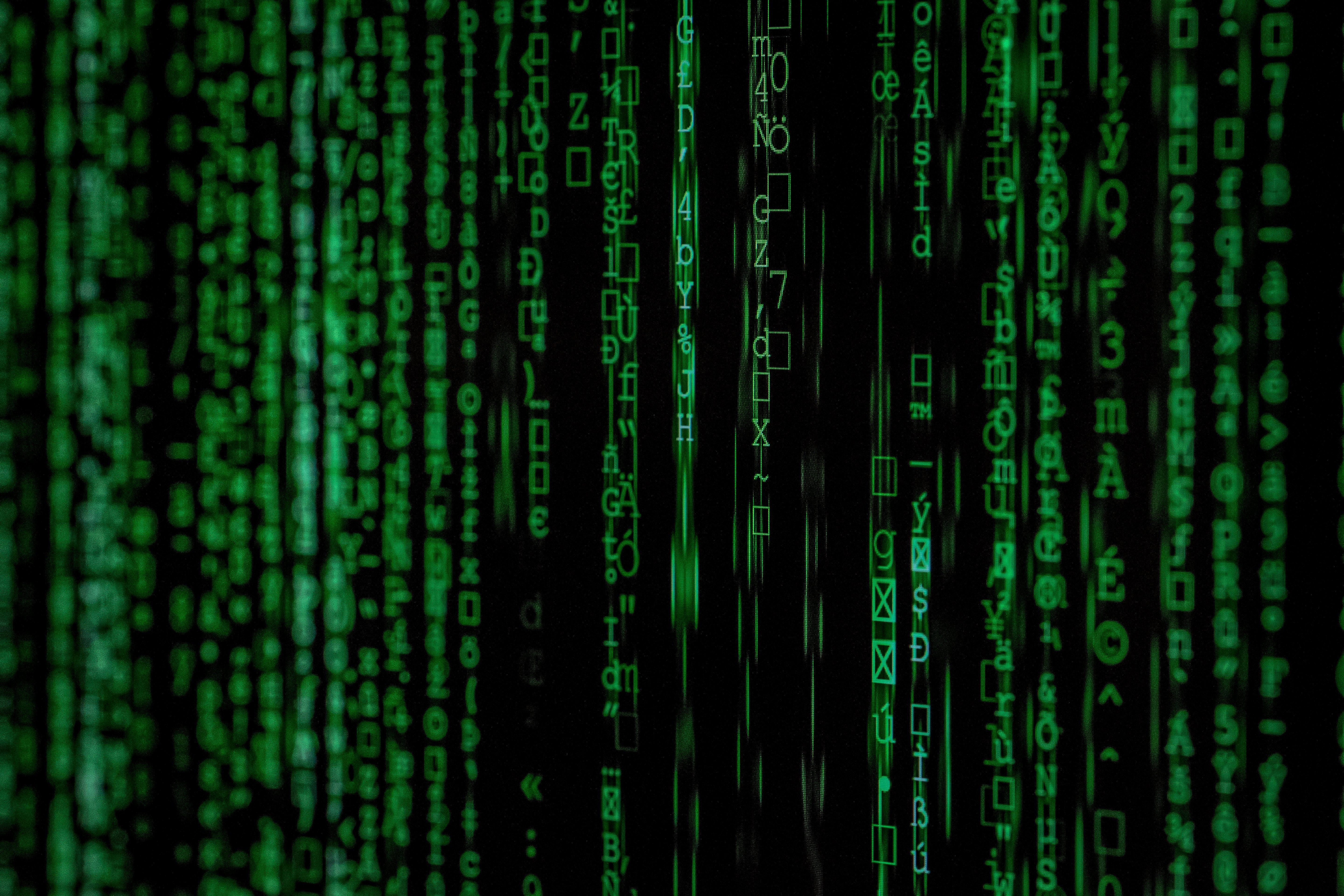 a close up of a green matrix code on a black background .