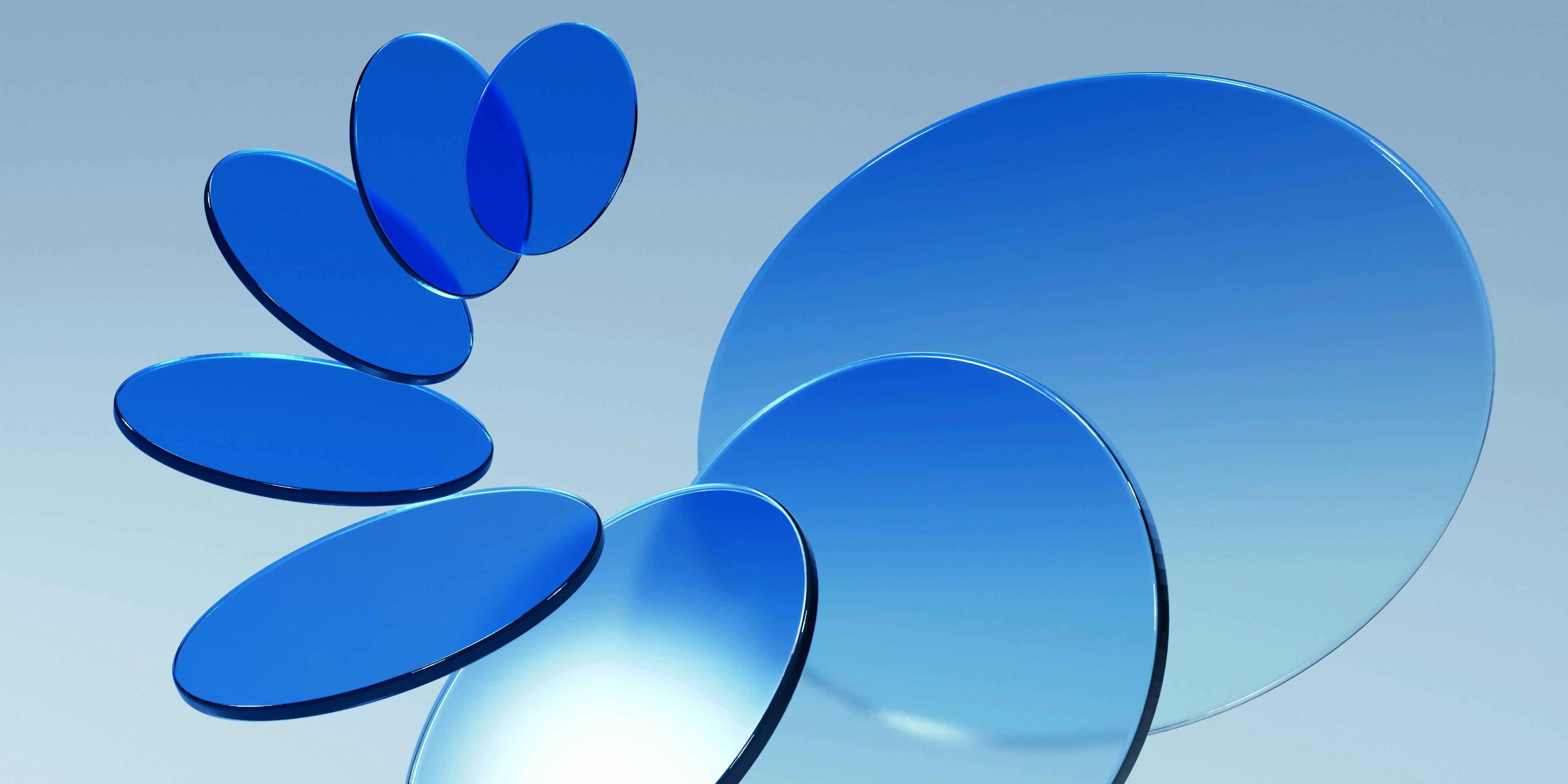 a group of blue circles are stacked on top of each other on a blue surface .