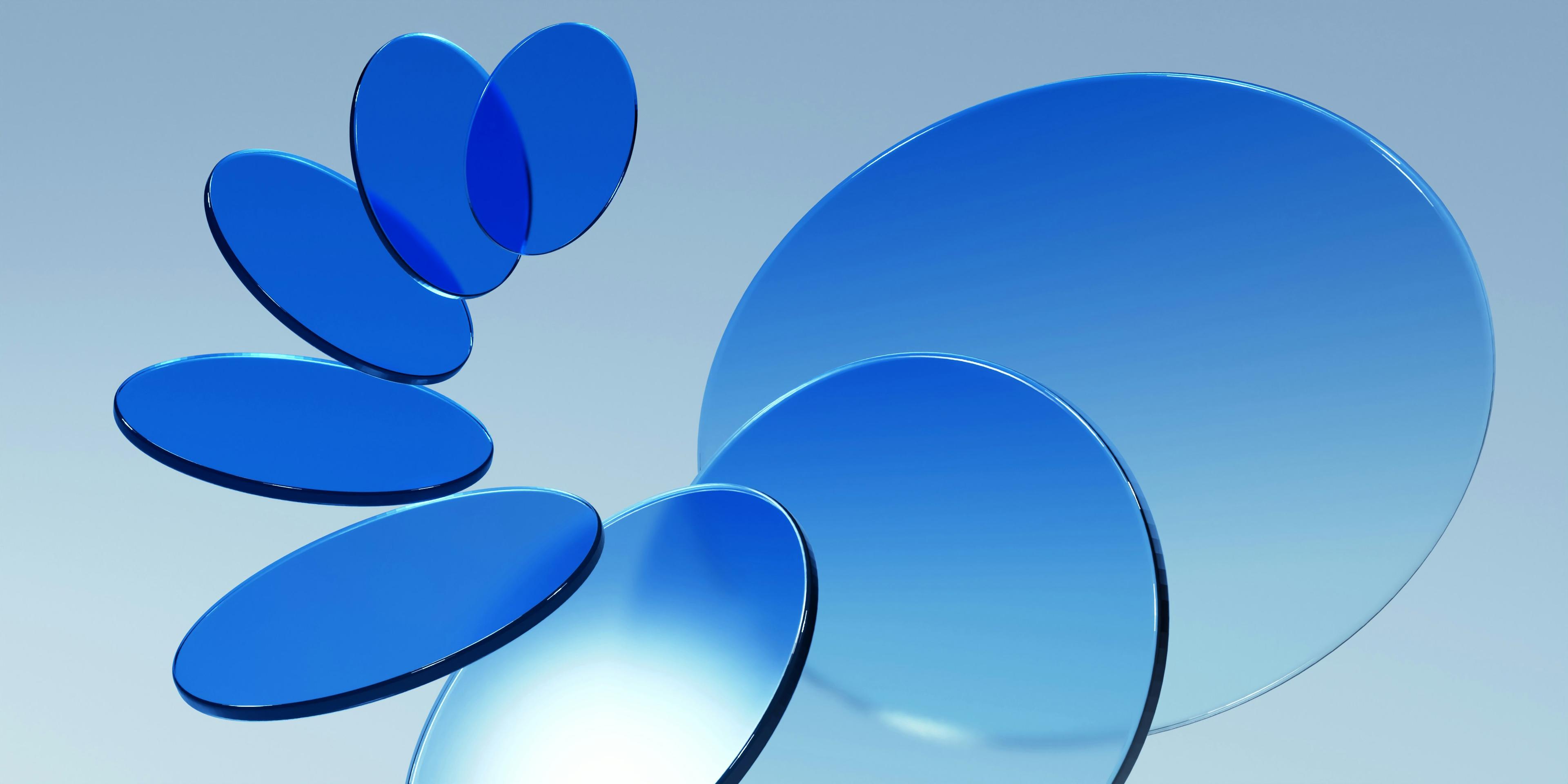 a group of blue circles are stacked on top of each other on a blue surface .