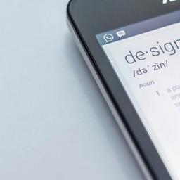 a close up of a cell phone with the word design on the screen .
