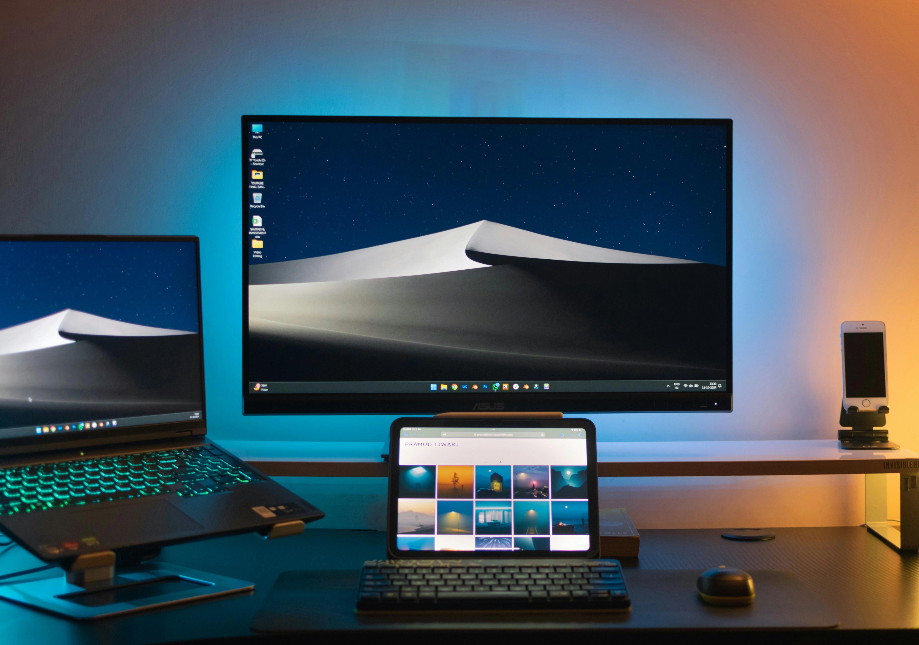 a computer monitor , laptop , tablet , keyboard and mouse are on a desk .