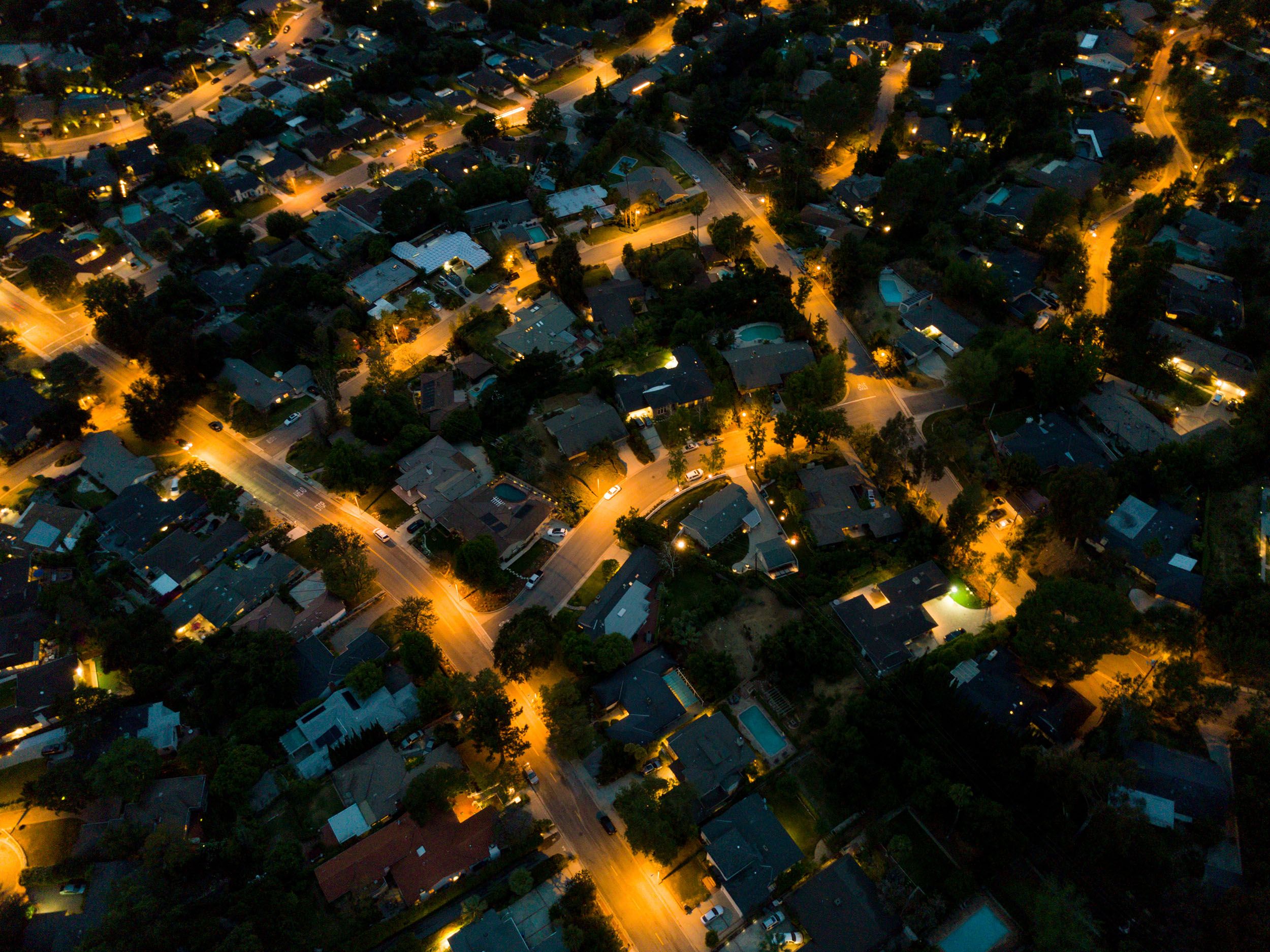 an aerial view of a residential neighborhood at night .