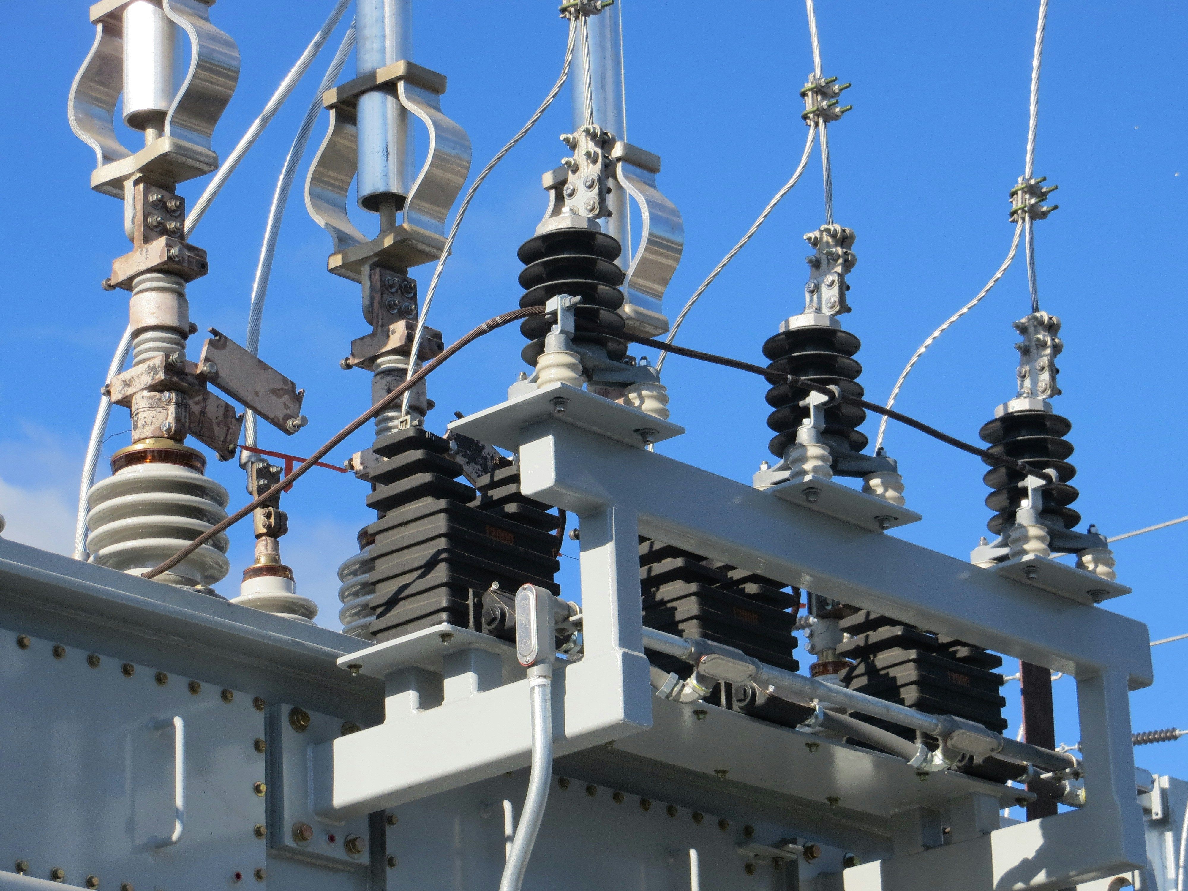 a close up of a power transformer with a blue sky in the background .