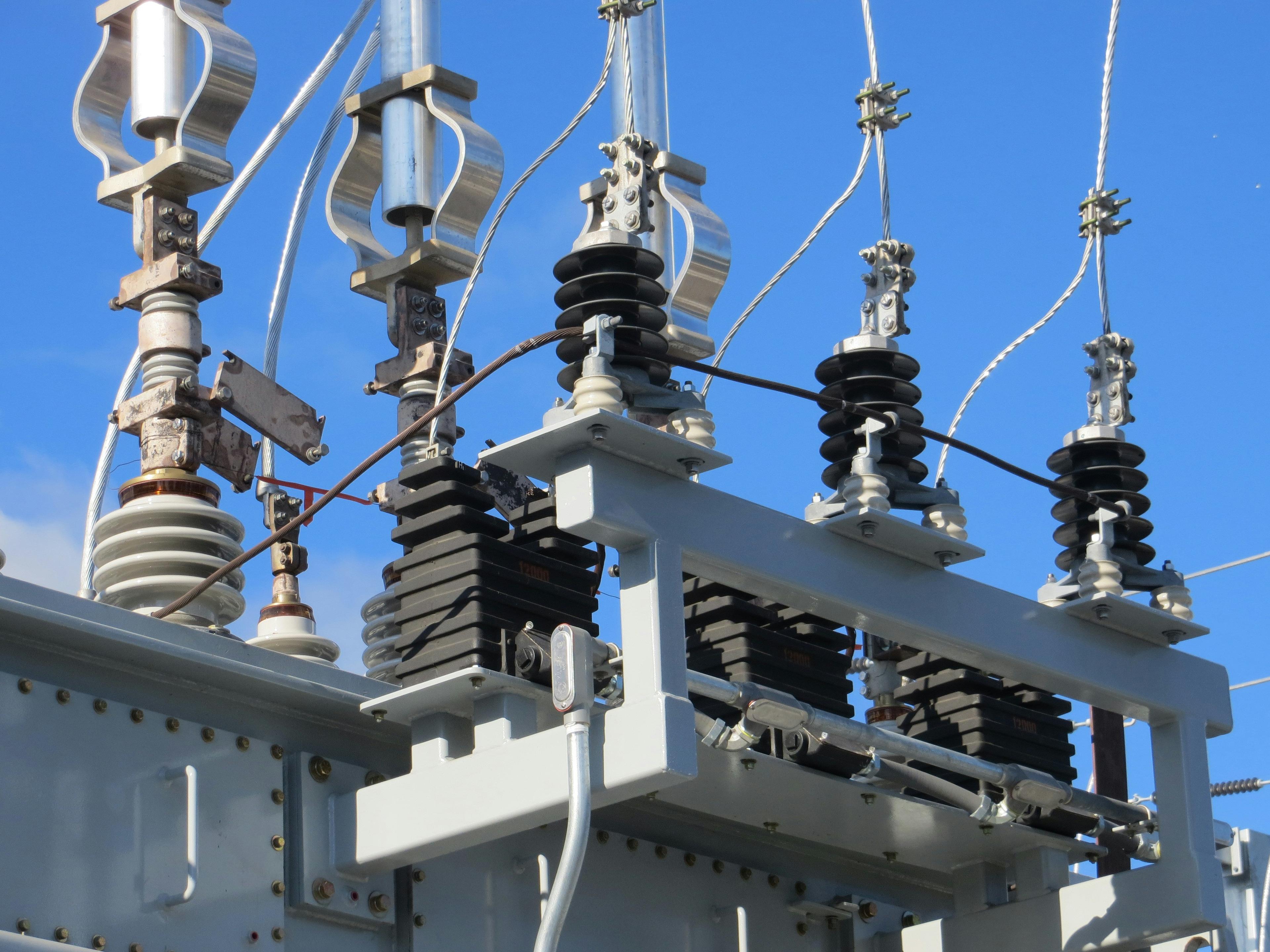a close up of a power transformer with a blue sky in the background .