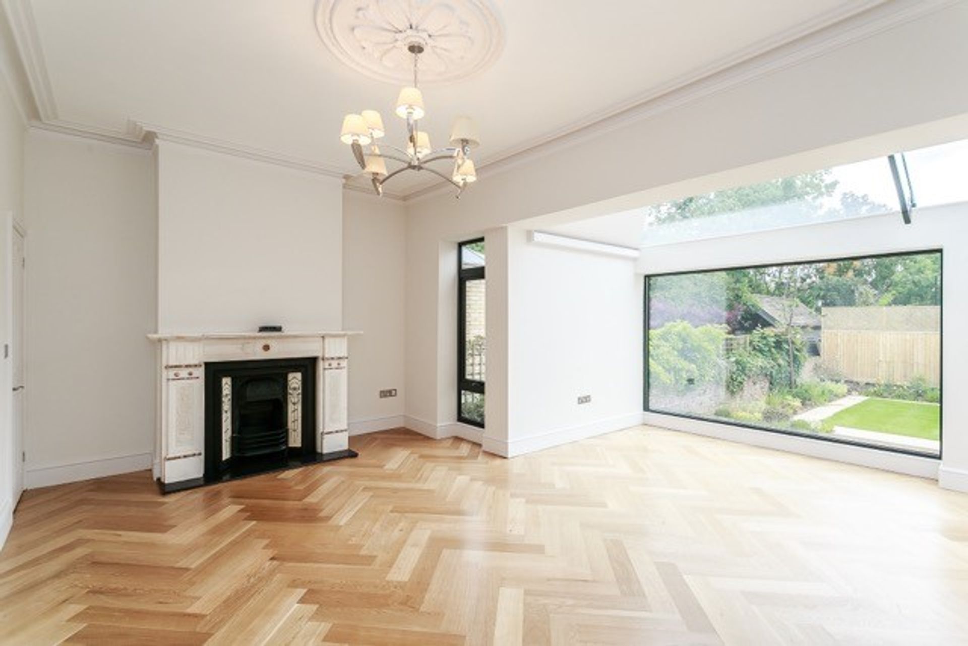 Living room with large picture window and Parque wood floor