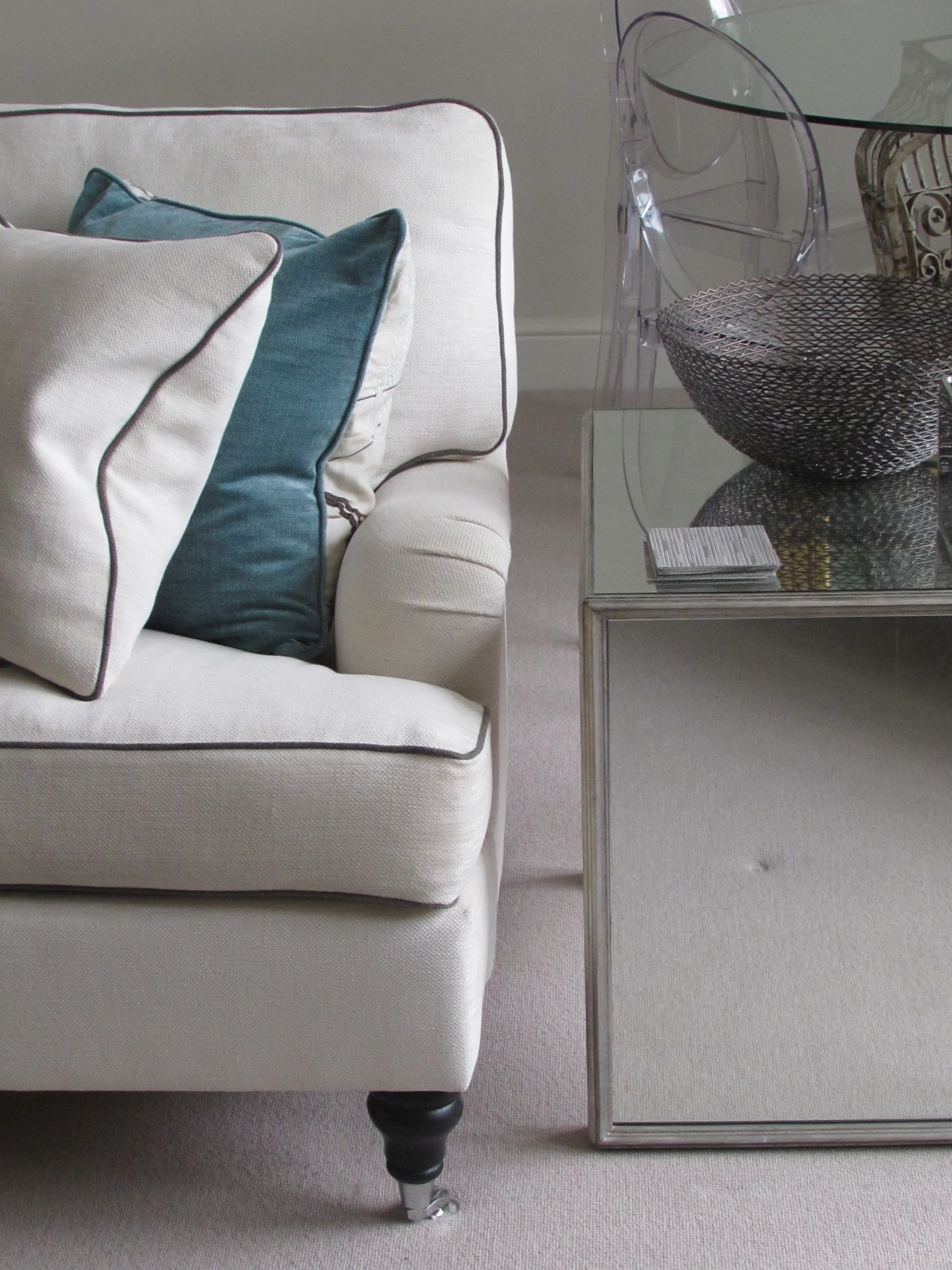 grey armchair with blue and grey cushions and side table