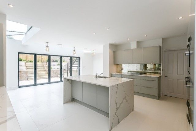 Modern kitchen with island and marble worktops