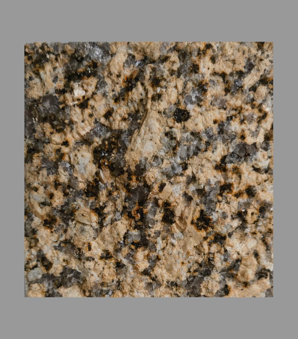 Tianshan Golden Diamond granite cobblestone sample with warm golden crystal surface for luxury estate landscaping.