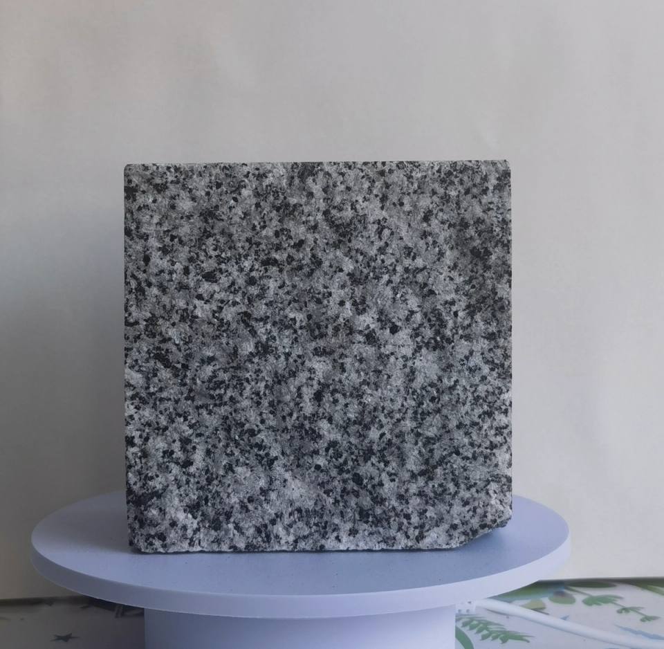 Paulo Grey split finish granite cobblestone with natural grey and black mineral grains, textured surface for outdoor landscape, driveway and public space paving.
