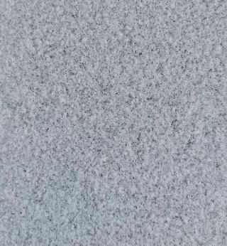 Close-up of Saxon Grey bush-hammered granite slabs featuring a uniform light grey crystal texture with a durable anti-slip bush-hammered finish, ideal for outdoor paving, wall cladding, landscape architecture and premium construction projects.