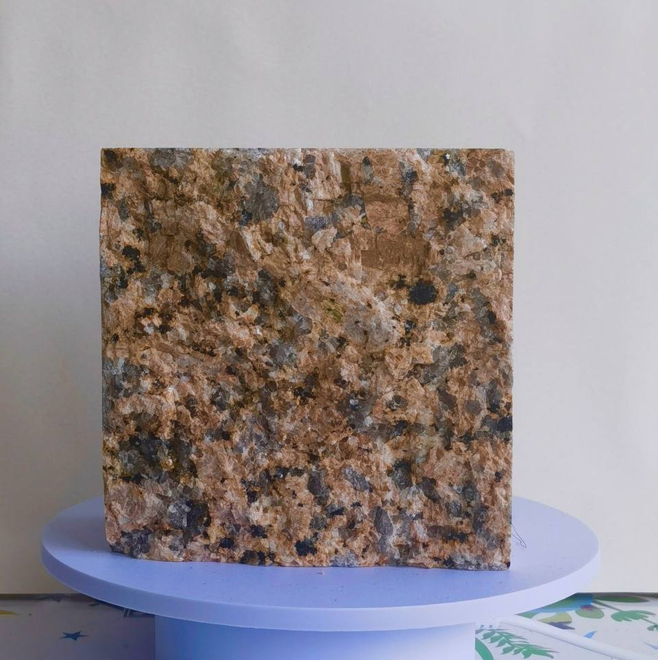 China Red split finish granite cobblestone with warm red-brown tones, contrasting natural mineral crystals and textured surface for landscape and outdoor paving projects