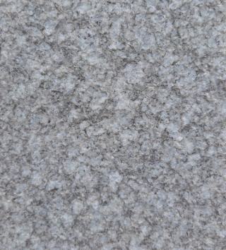 Close-up of Crystal Grey textured flamed granite slab featuring a uniform light grey crystal texture with a durable anti-slip textured finish, ideal for outdoor paving, façade cladding, landscape architecture and premium construction projects.
