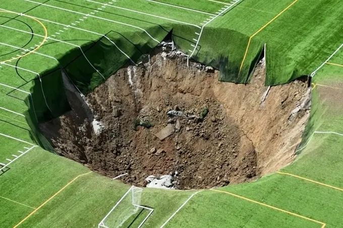 Mother Nature takes a bite out of Georgia as a giant sinkhole opens up, swallowing several football fields