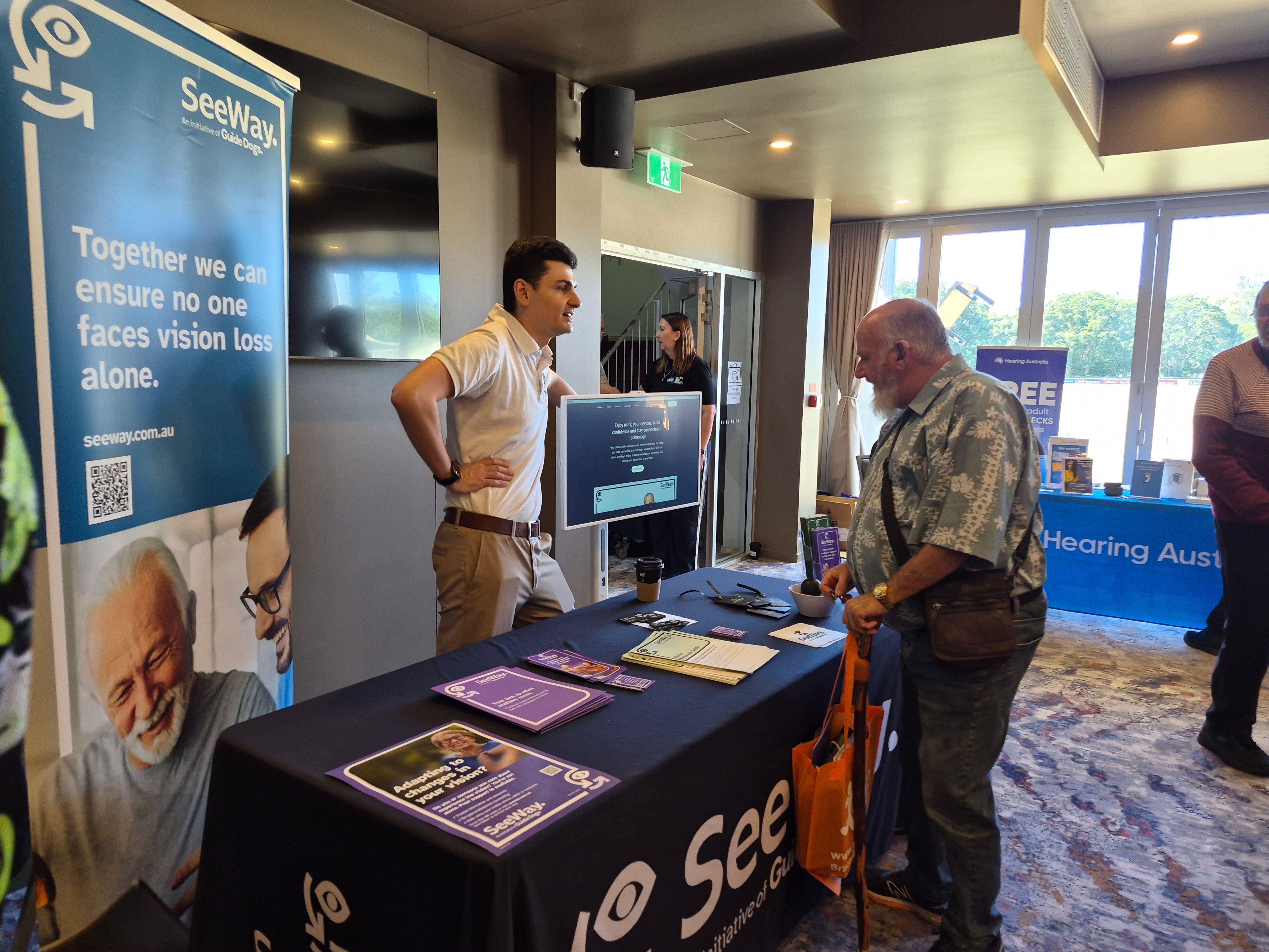 Michael from SeeWay talks with an attendee at a Seniors Expo.