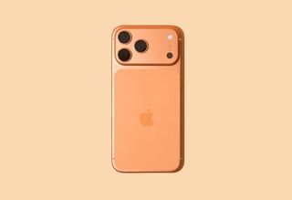 An orange iPhone 17 on a pale orange background