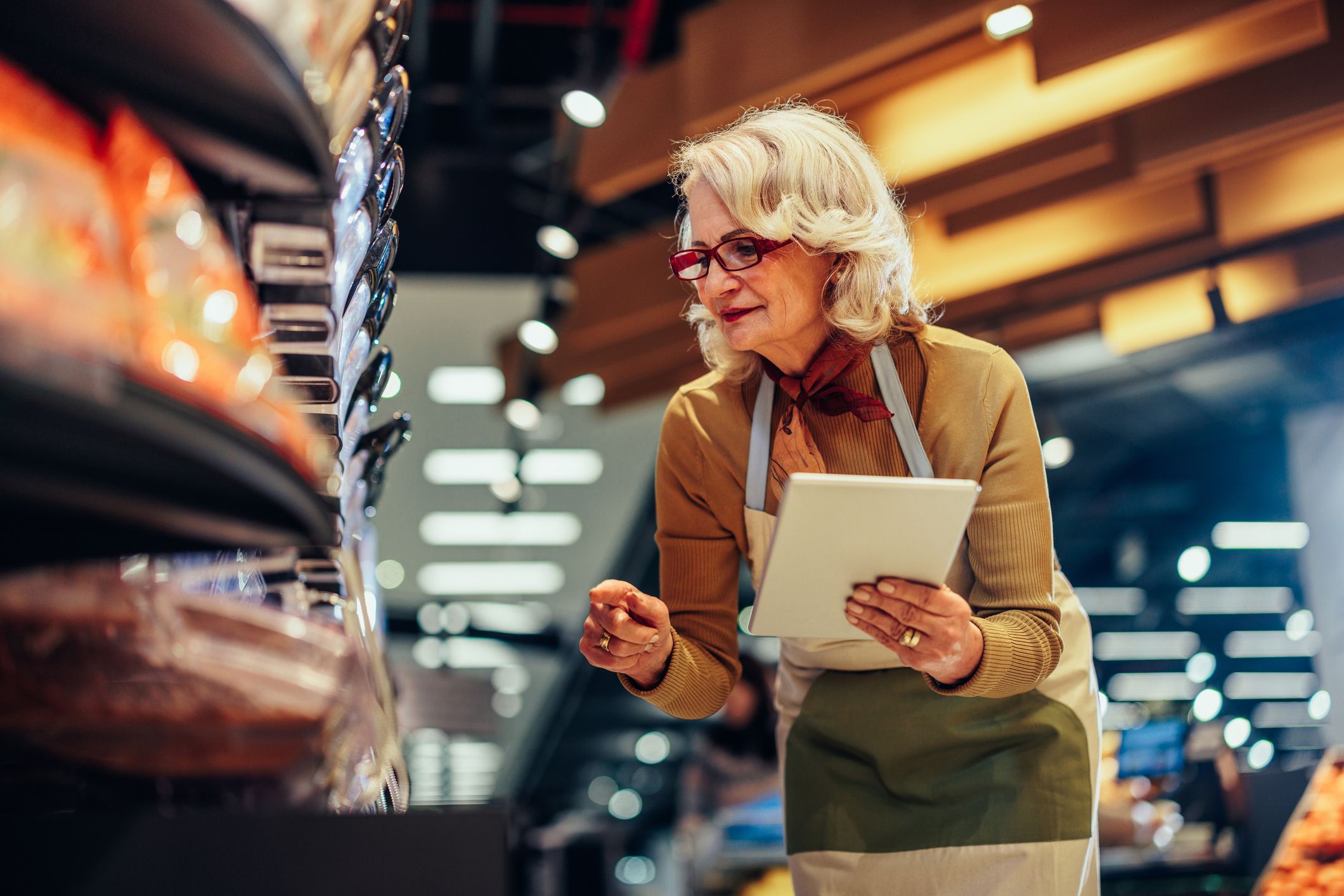 Older woman performing inventory at work.