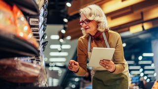 Older woman performing inventory at work.