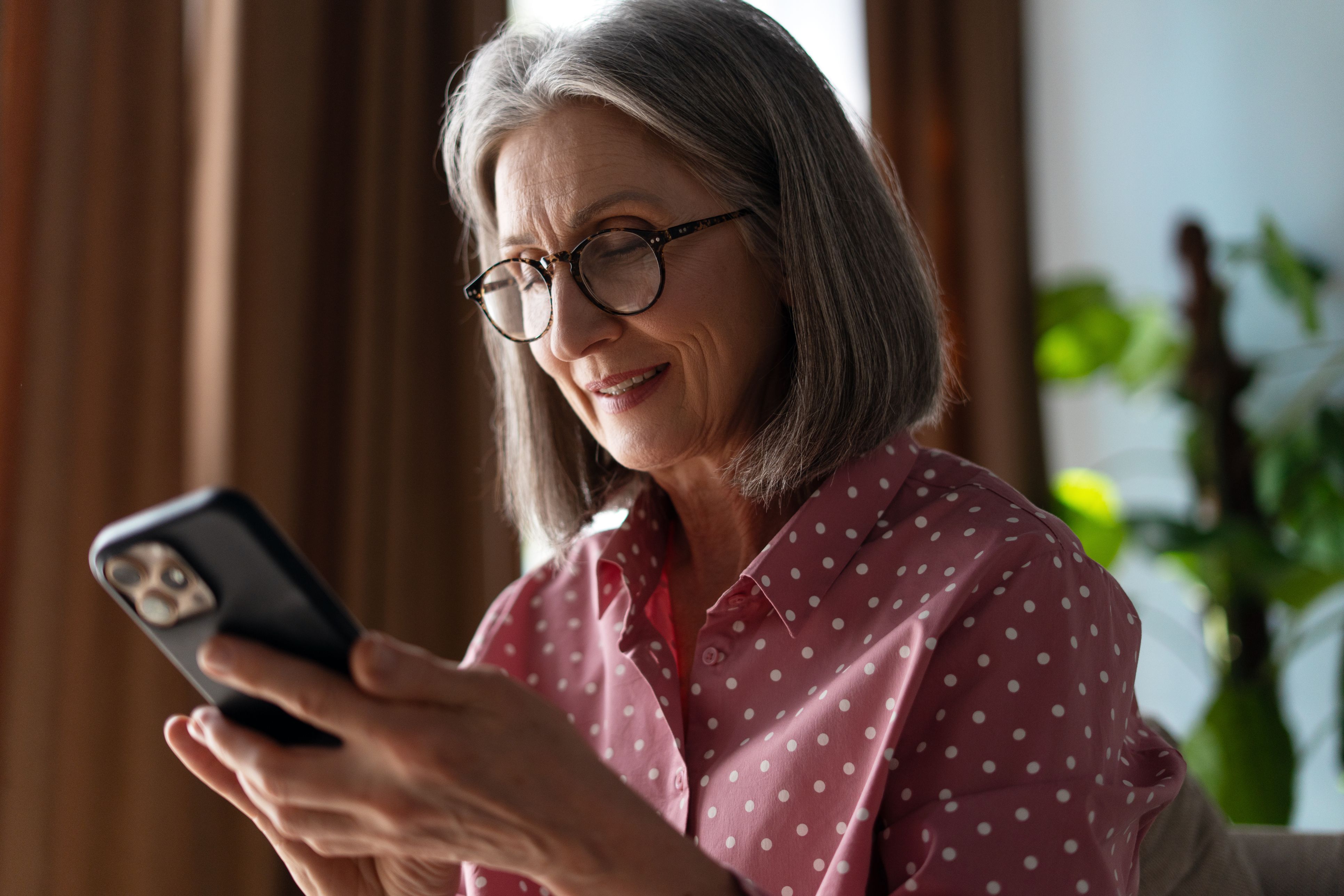 Older woman using a smartphone at home