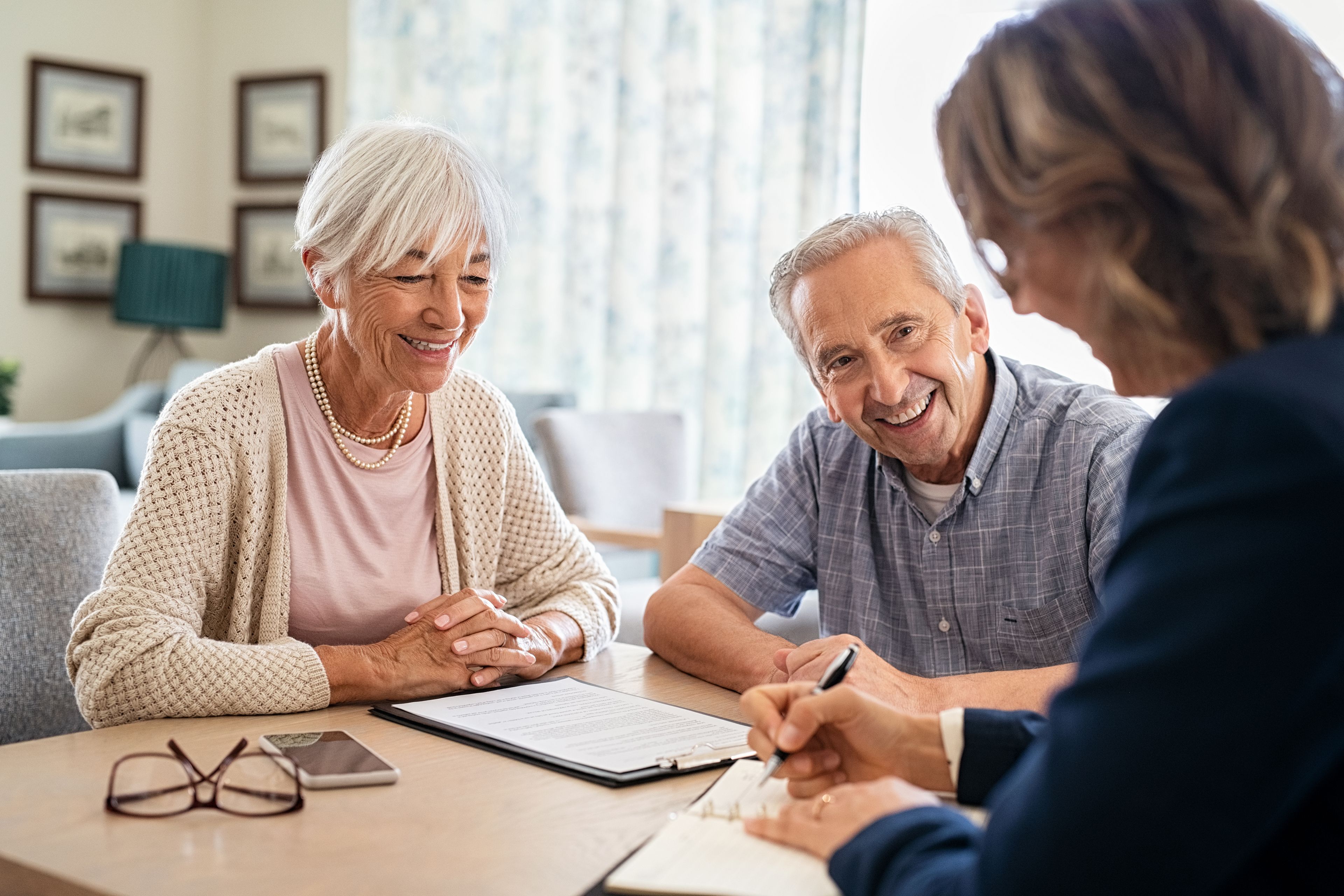 Older couple seated at a table with financial consultant