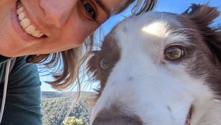 A photo of April with her dog at the beach