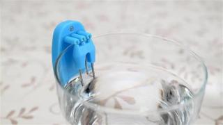 A blue liquid level indicator in a glass of water