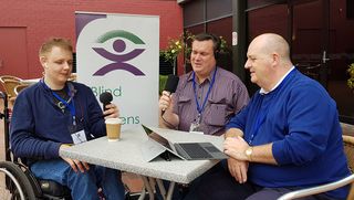 Three men talking together for Blind Citizens Australia's radio show New Horizons.