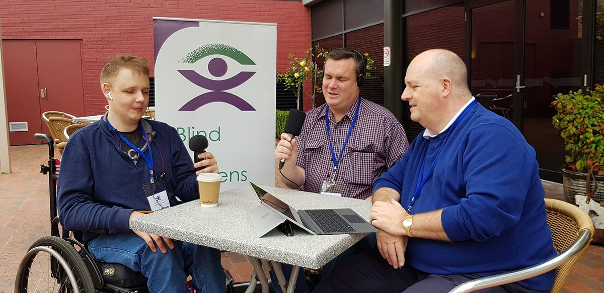 Three men talking together for Blind Citizens Australia's radio show New Horizons.
