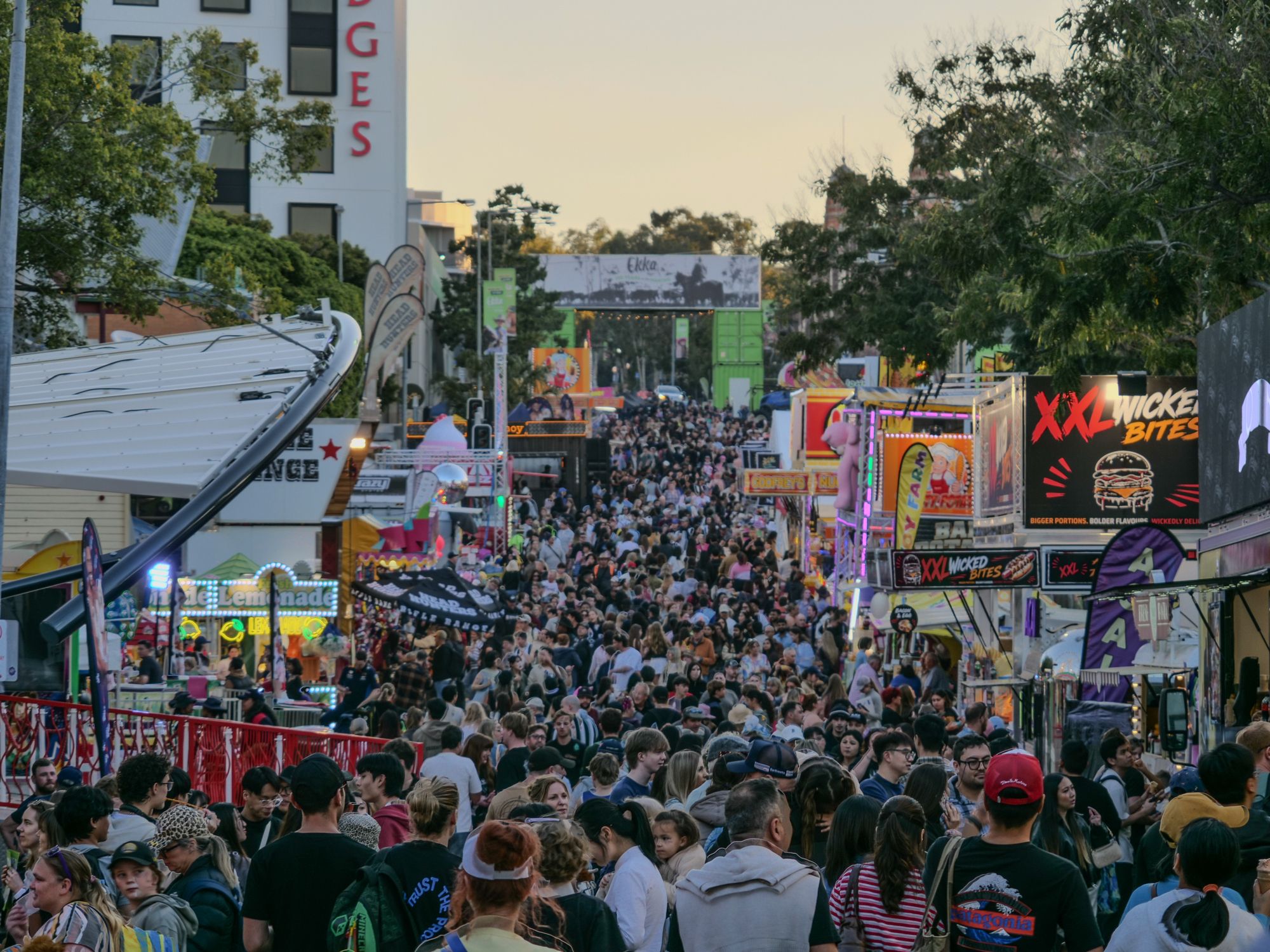 A large crowd gathered for a festival on the street.