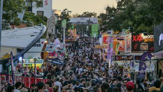 A large crowd gathered for a festival on the street.
