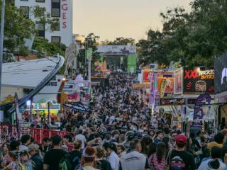 A large crowd gathered for a festival on the street.