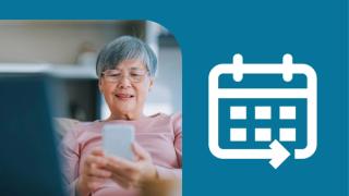 An woman using her phone at home. Next to her is a white calendar icon on a blue background.