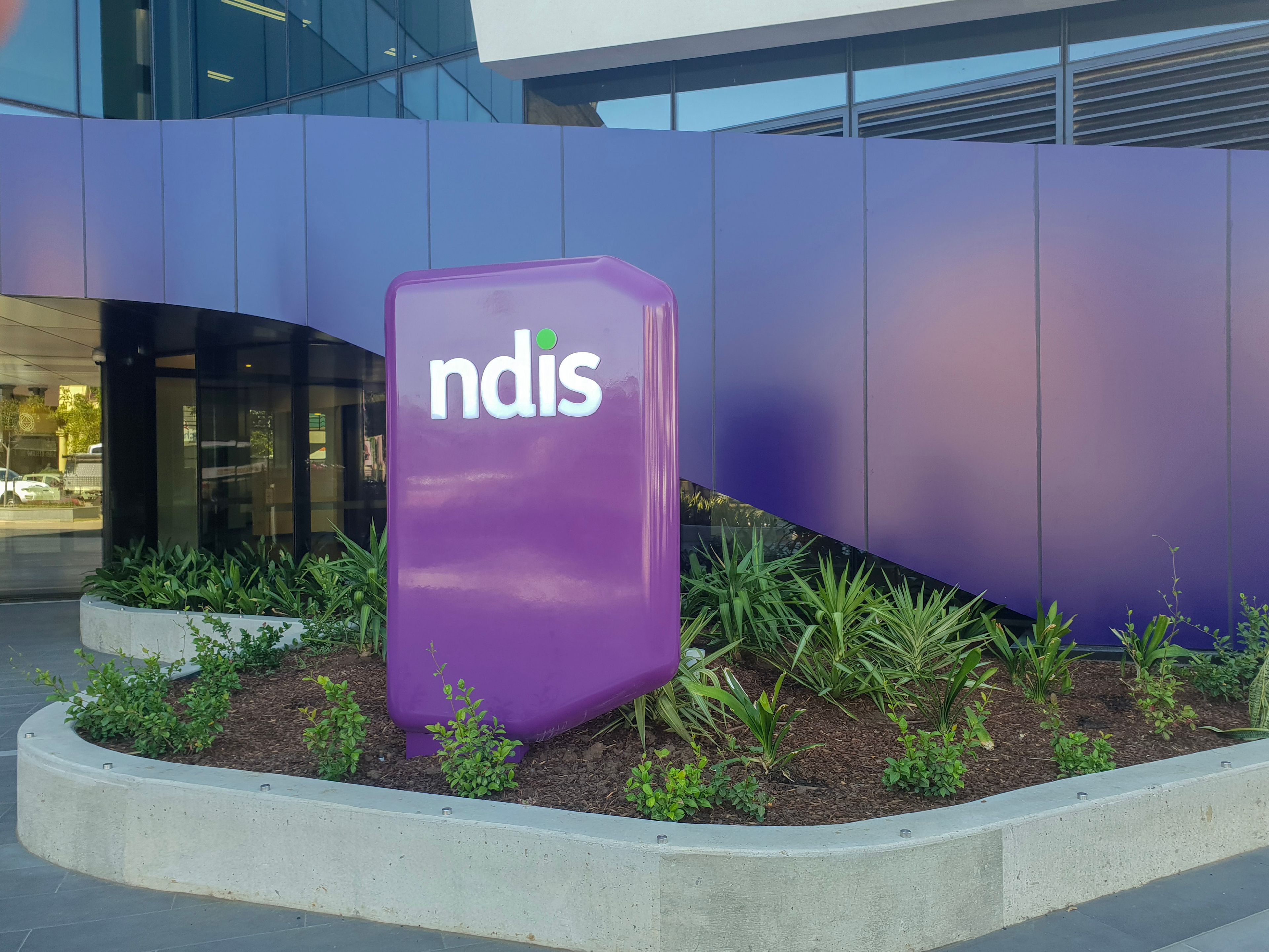 Purple NDIS sign outside building