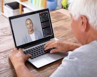 A man watching an online skills session on a laptop.