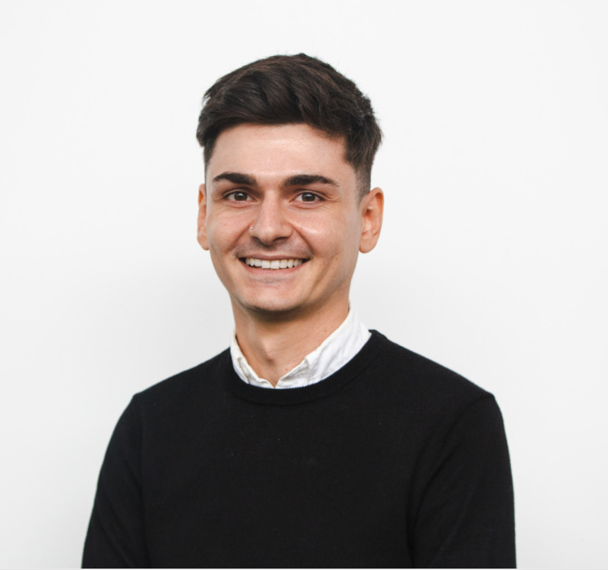 A headshot of Michael smiling at the camera.