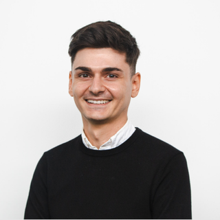 A headshot of Michael smiling at the camera.