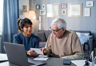 Older person having a low vision assessment with an orthoptist in a home environment