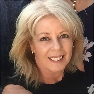 Carmel Harris smiles at the camera for a headshot.