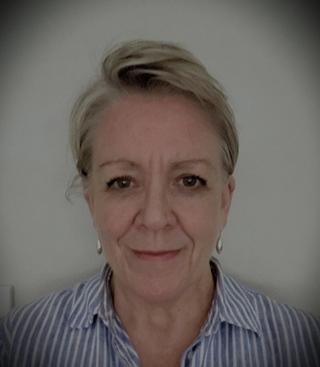 A headshot of Karen Warwick smiling at the camera