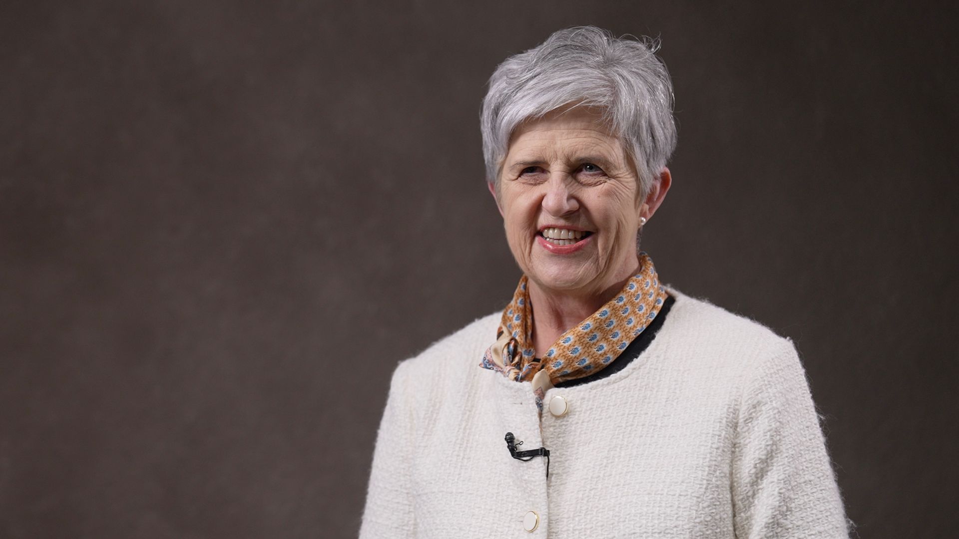 A headshot of Suzi smiling at the camera