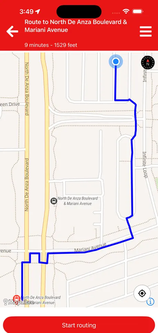 A screenshot of the Lazarillo app guiding a route to a bus stop.
